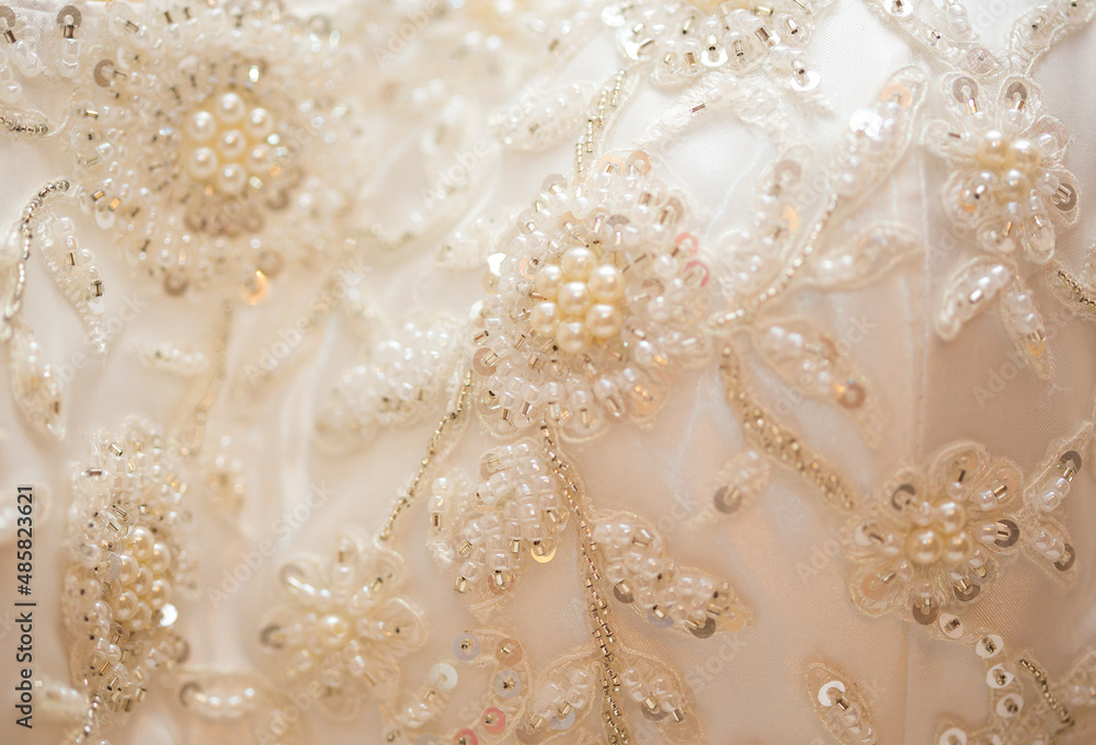 Fabric of wedding dress embroidered with pearls and sequins Fabric of wedding dress embroidered with pearls and sequins
