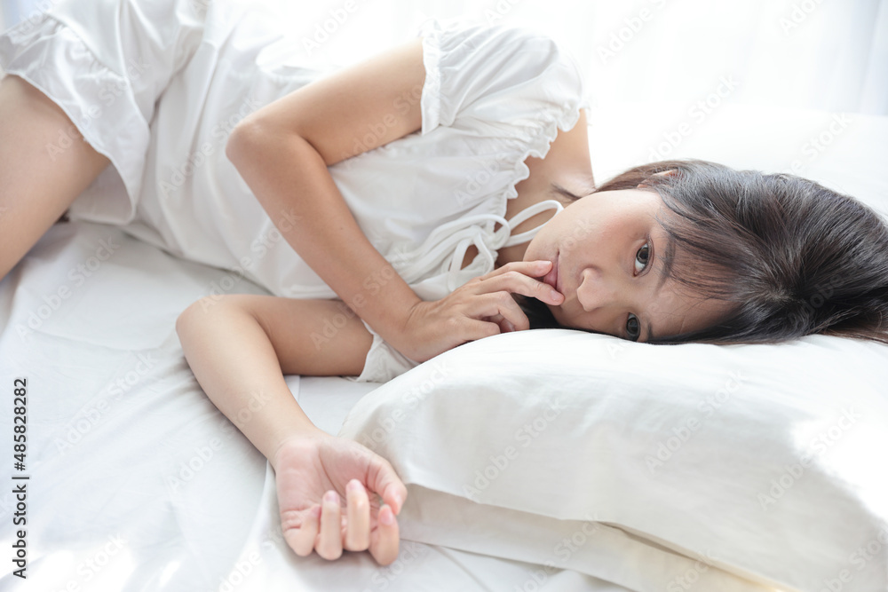 Beautiful young woman legs sleeping in the morning at white bedroom Beautiful young woman legs sleeping in the morning at white bedroom