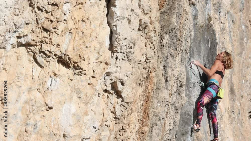 beautiful girl climbs the rock, sport climbing in nature, extreme sport, fitness and beauty beautiful girl climbs the rock, sport climbing in nature, extreme sport, fitness and beauty