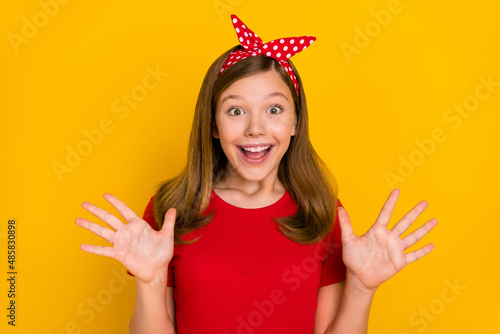 Portrait of excited cheerful charming sweet girl scream shout in excitement big sale bargain isolated on yellow color background