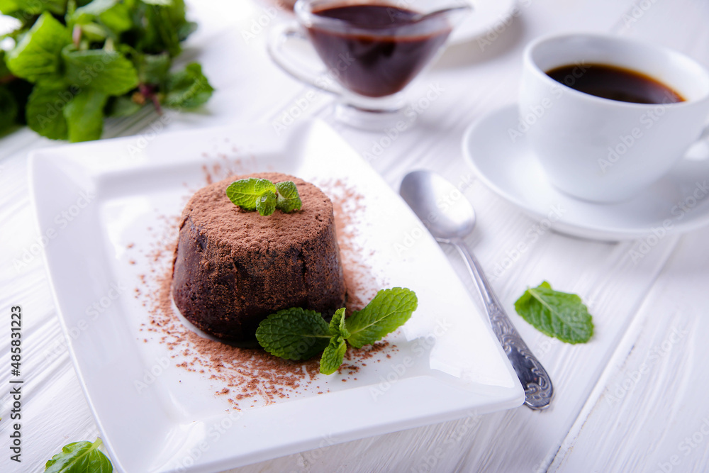 Chocolate fondant decorated with mint on a white background Chocolate fondant decorated with mint on a white background