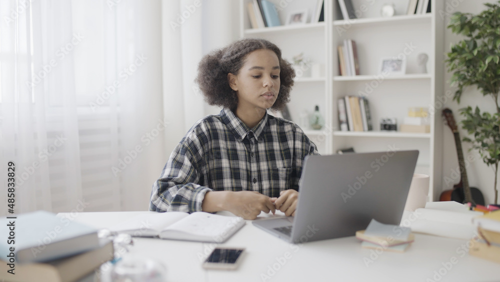 Upset school pupil reading bad news on laptop, failed test, disappointment Upset school pupil reading bad news on laptop, failed test, disappointment