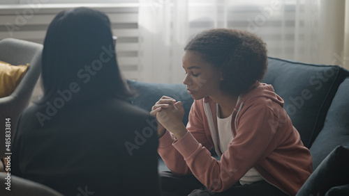 Slika na platnu Female therapist talking to upset teen girl at counselling session, psychology