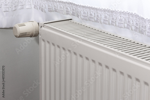 Wallpaper Mural Corrugated white heating radiator and temperature knob. Heater controller in selective focus. Torontodigital.ca