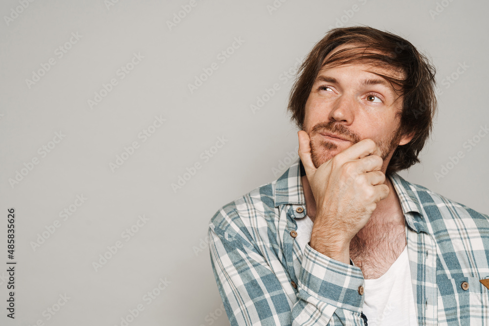 White puzzled man wearing shirt posing while looking aside White puzzled man wearing shirt posing while looking aside
