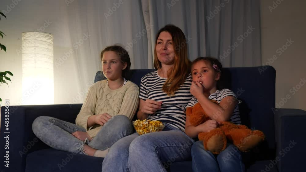 stay home. family - mom, daughter and small child are watching tv. coronavirus happy family together concept. happy family watching tv together. kid quarantine dream. people watching online movies stay home. family - mom, daughter and small child are watching tv. coronavirus happy family together concept. happy family watching tv together. kid quarantine dream. people watching online movies