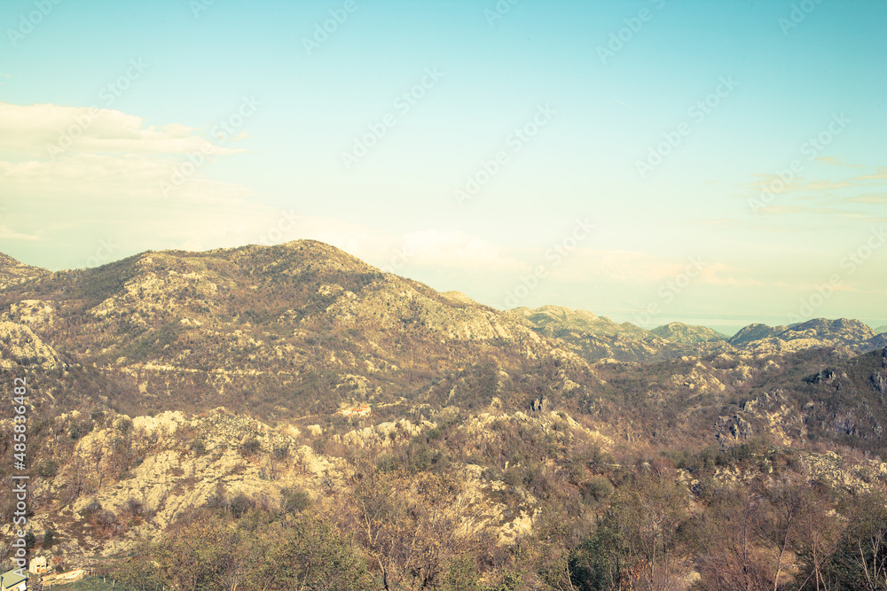 Aerial panoramic view of landscape with mountains and blue sky with white clouds. The horizontal landscape in mountains. Travel trip background for a post, screensaver, wallpaper, postcard, poster
