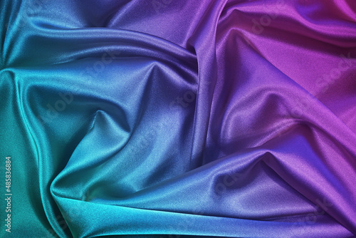 Pink tuquoise silk satin. Gradient. Wavy folds. Shiny fabric surface. Beautiful purple teal background with space for design.  photo