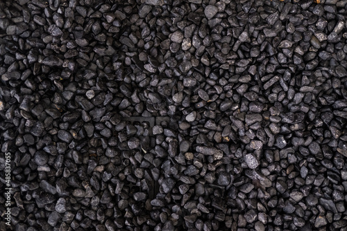 Pebbles texture background, dark wet pebble