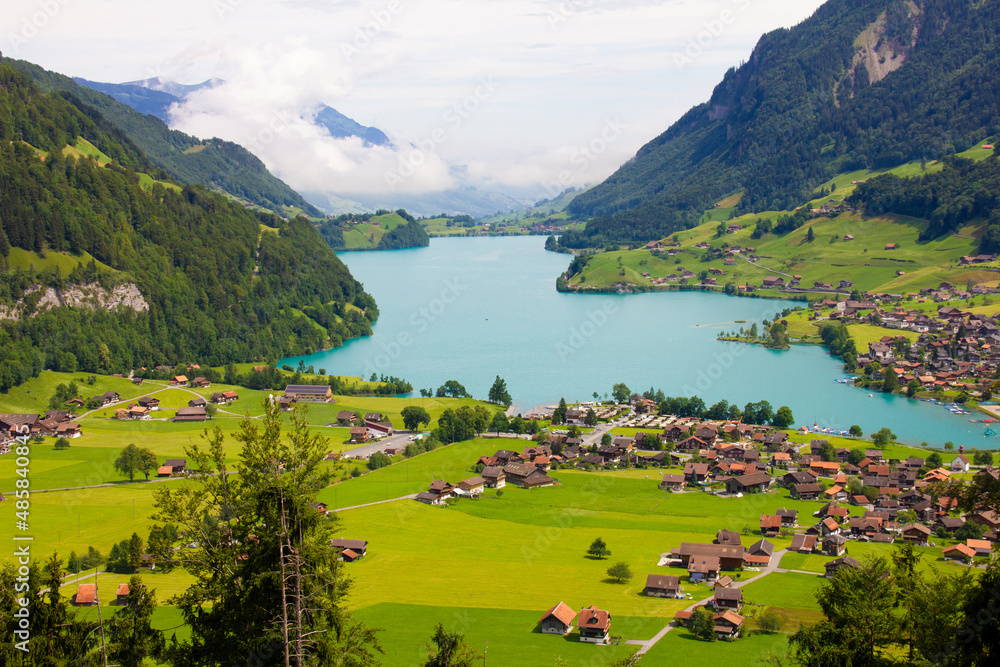 Lake, mountains and village. Aerial view on village in Austria