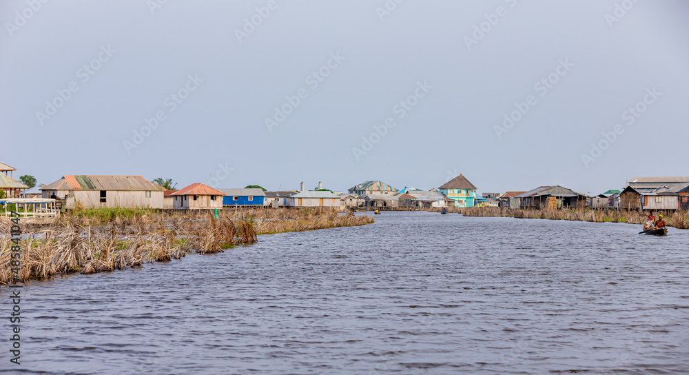 beach huts on the shore of the river