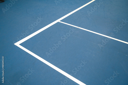 White lines on blue hard tennis court.