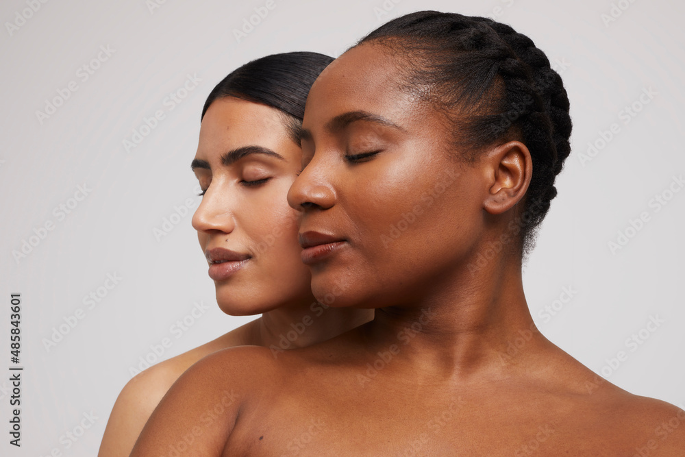 Studio shot of two pensive women with eyes closed
