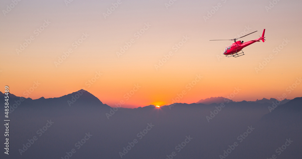 helicopter in flight at sunset in the high mountains helicopter in flight at sunset in the high mountains