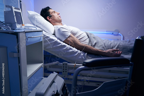Adult patient in white t-shirt resting after procedures