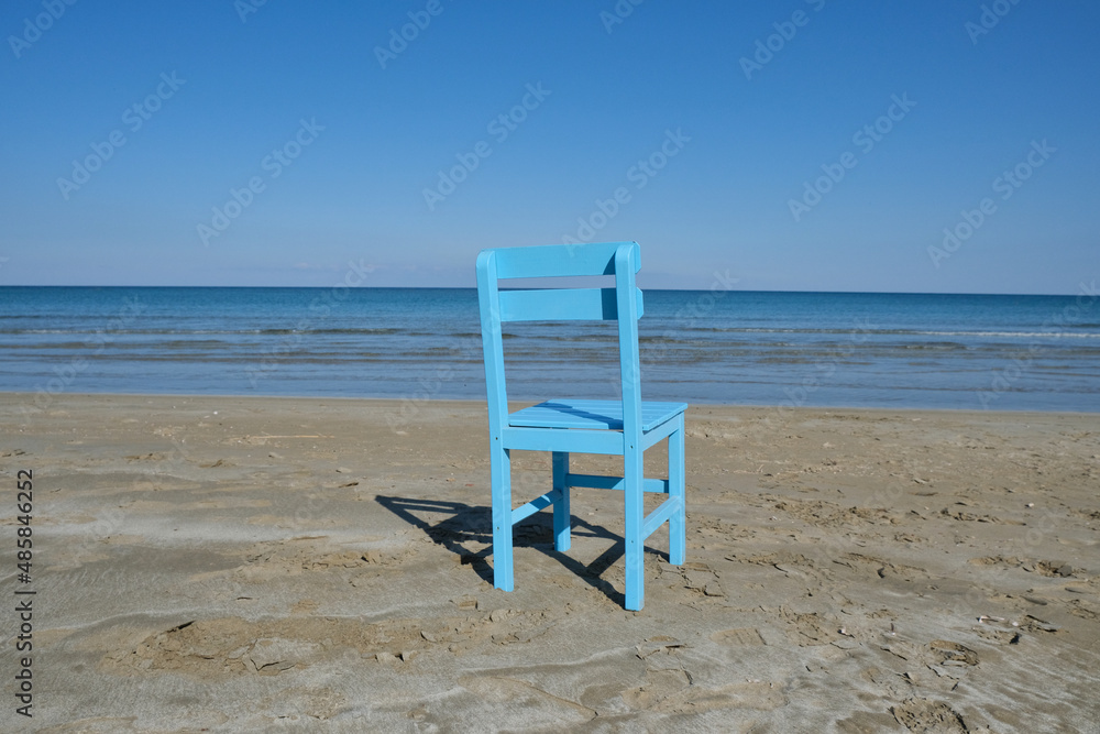 Single of the blue and wooden chair with the seascape.