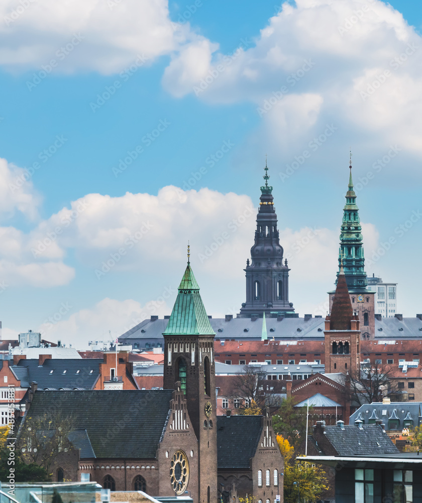 Skyline of Copenhagen with towers and spires in a bright sunny day.