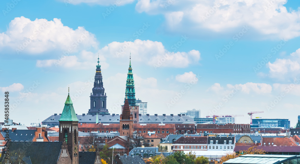 Skyline of Copenhagen with towers and spires in a bright sunny day.