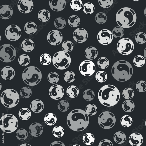 Grey Yin Yang symbol of harmony and balance icon isolated seamless pattern on black background. Vector