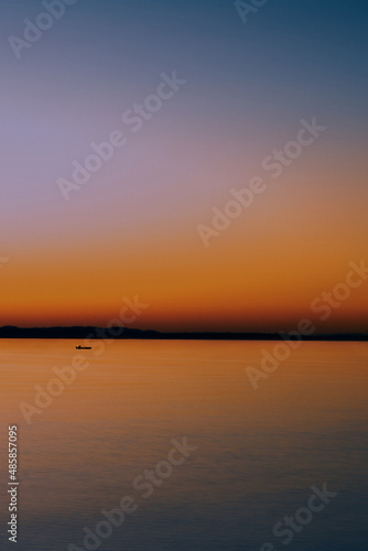 Boat at sea at sunset © Erika