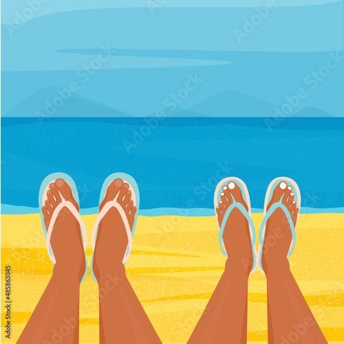 A guy and a girl are lying on the sand. Flip-flops on his feet.