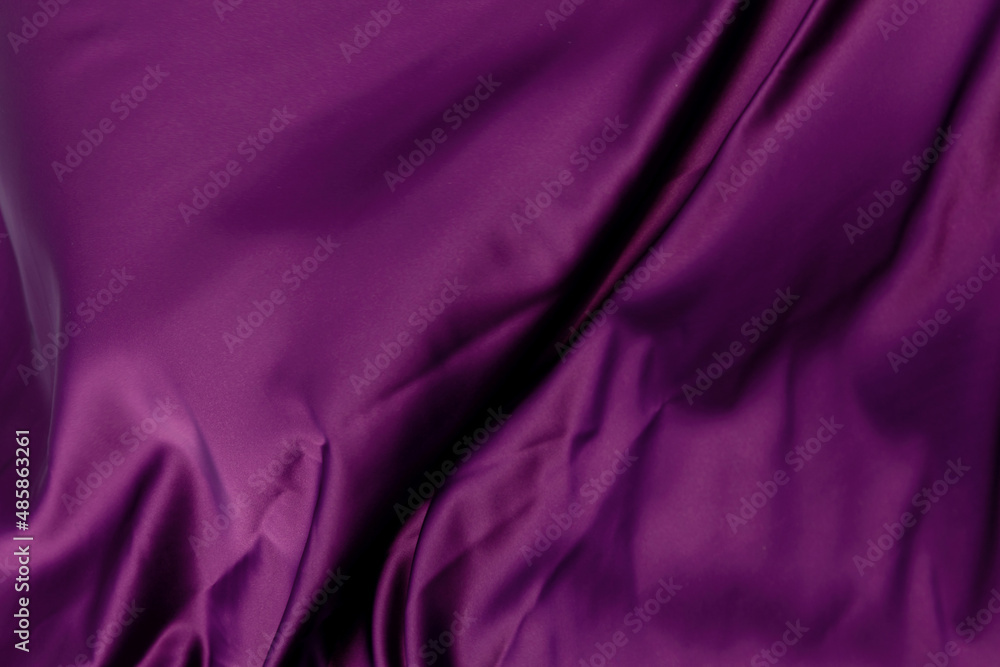 Purple violet satin cloth lies crumpled in waves Purple violet satin cloth lies crumpled in waves