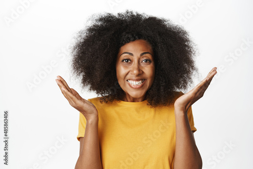 Fototapeta Close up portrait of enthusiastic african american woman smiling and cheering