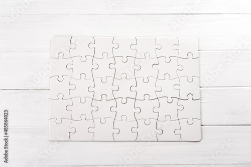 Rectangular jigsaw puzzle on white table photo