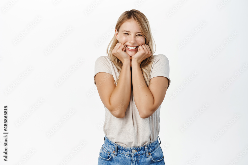 Surprised and excited blond girl screams of joy, reacting amazed and happy at promo sale, super big news, standing over white background Surprised and excited blond girl screams of joy, reacting amazed and happy at promo sale, super big news, standing over white background