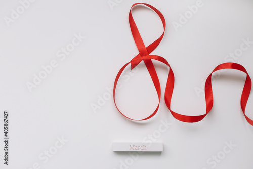 Eight made of red ribbon. 8 March greeting card template. International Women's day background, banner, poster or brochure