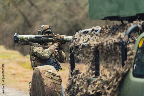 фотографія Bazooka loading behind disguise army camouflaged truck