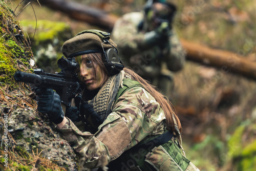 Heartless female general aiming to kill threat on battlefield . High quality photo © PoppyPix