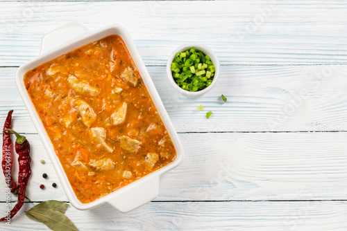 White wine chicken stew in baking dish.Top view, copy space. photo