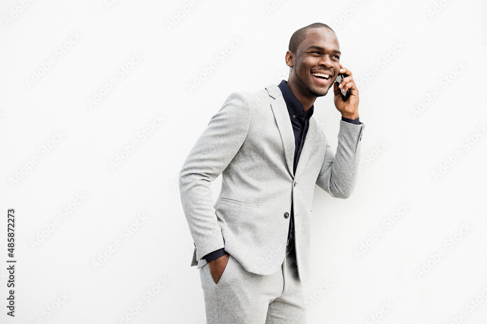 African American businessman talking with cellphone by isolated white background African American businessman talking with cellphone by isolated white background
