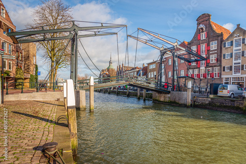 The Damiate Bridge in the historic center of the Dutch city of Dordrecht was built in 1857. The bridge over the water of an inland harbor connects two quays: the Wolwevershaven and the Kuipershaven. photo