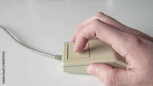 Hand Using a Retro Computer Mouse from 80s 90s Close Up photo