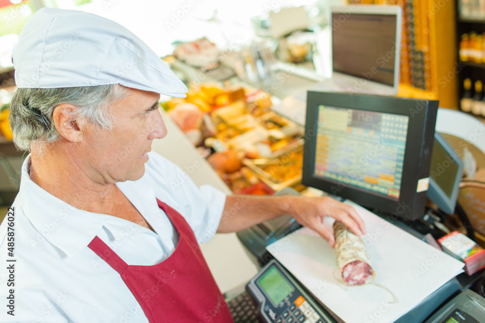 a butcher is weighing produce a butcher is weighing produce