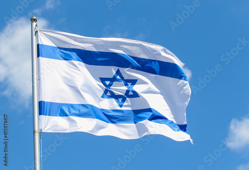 Israel national flag on a background of blue sky