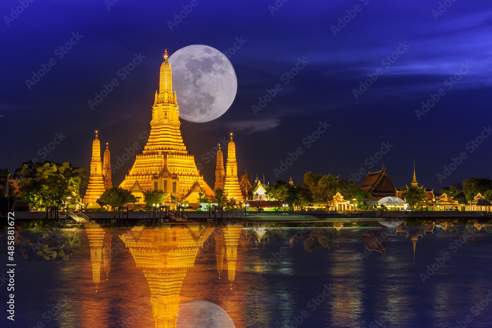 Wat arun in night with super full moon,Wat Arun at night with Light gold is the oldest temple of the Chao Phraya River and Full moon In the dark sky in Bangkok Thailand
