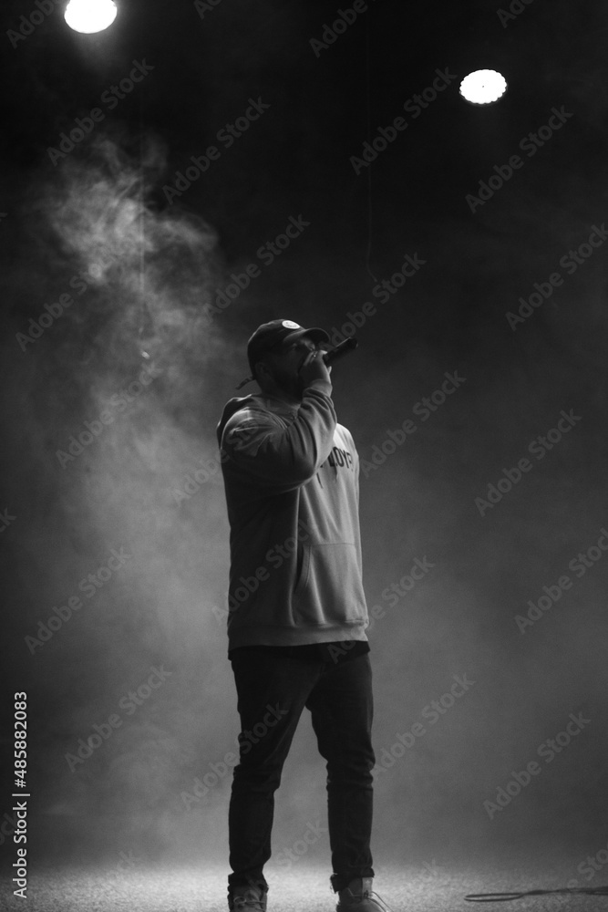 singer and rapper on stage in smoke - obrazy, fototapety, plakaty 