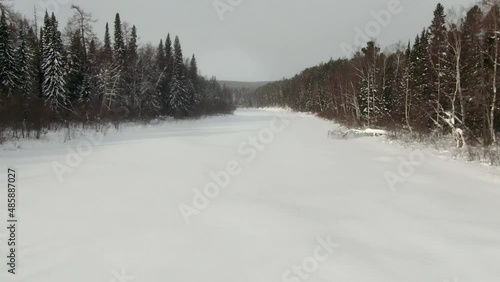 Wallpaper Mural Drone flying over the frozen river Lozva, low flight, smooth rise, the road to the Dyatlov Pass Torontodigital.ca