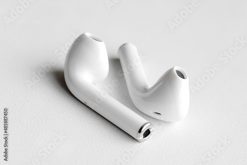Wireless headphones on a white background, Close-up. The concept of modern technology.