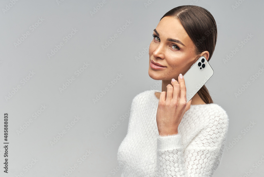 Young beautiful charming woman talking on the mobile phone Young beautiful charming woman talking on the mobile phone