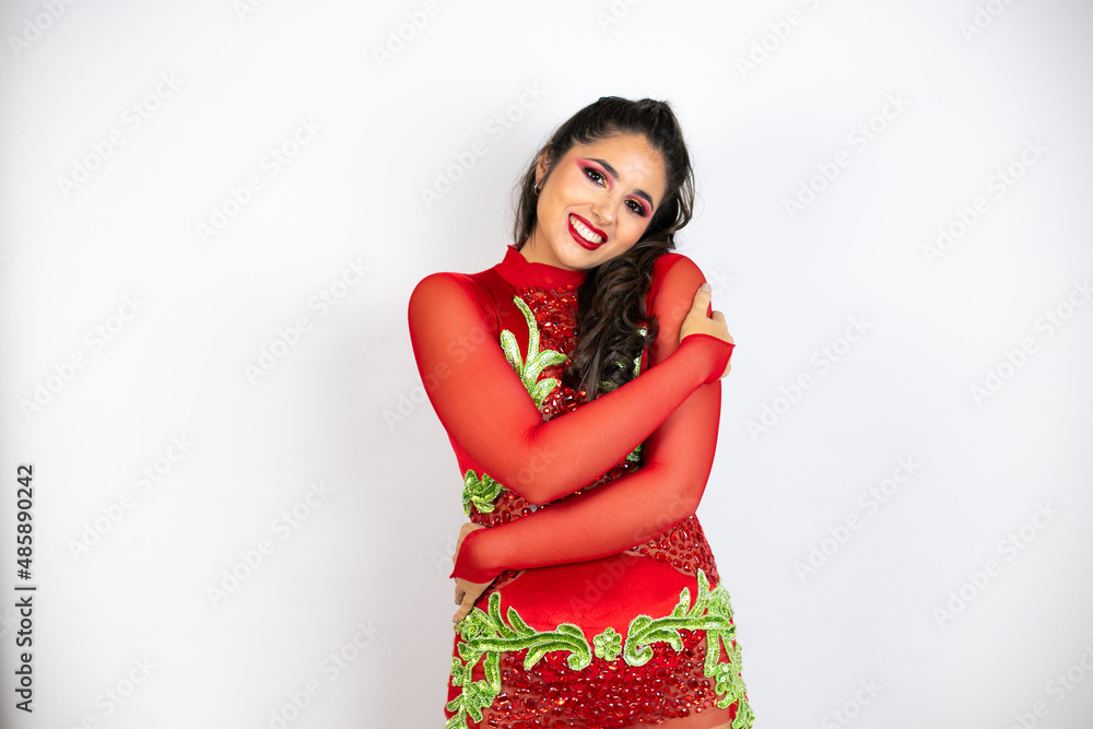 Young beautiful woman wearing carnival costume over isolated white background hugging oneself happy and positive, smiling confident Young beautiful woman wearing carnival costume over isolated white background hugging oneself happy and positive, smiling confident