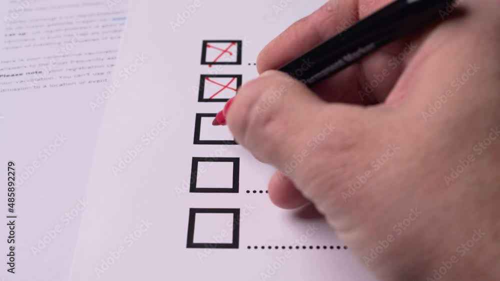 Hand holds a red pen and fills out a checklist of questions Stock Video ...