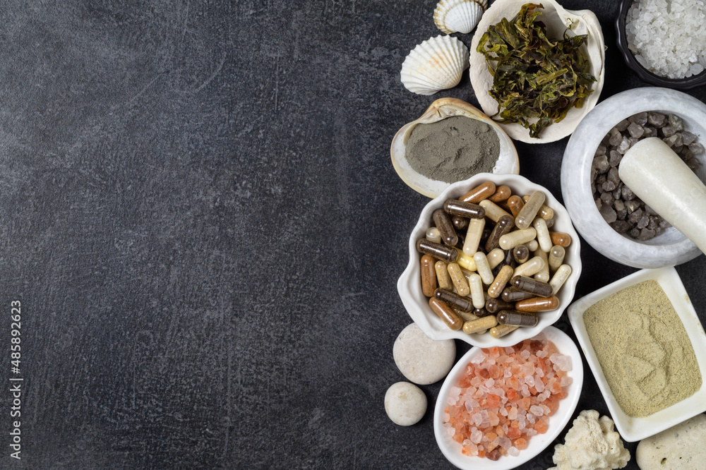 Dietary supplements in capsules, various crystals of salt, algae and sea minerals in plates and in mortar Dietary supplements in capsules, various crystals of salt, algae and sea minerals in plates and in mortar
