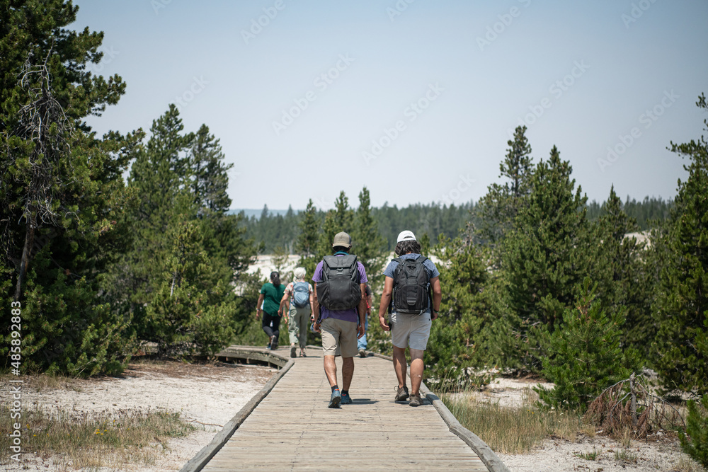 A family walking on a board walk on a National Park