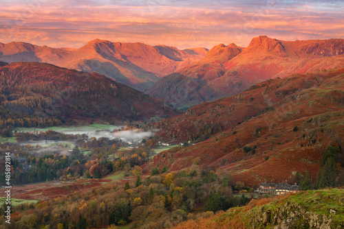 Breathtaking Winter sunrise light on the Langdale mountain range in the Lake District, UK. Taken from Loughrigg Fell on a beautiful Autumn morning. 
