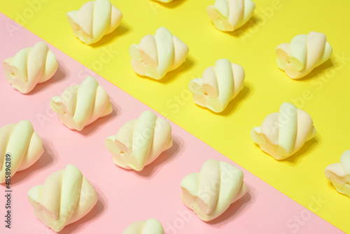apricot and strawberry marshmallows in rows on pink and yellow background
