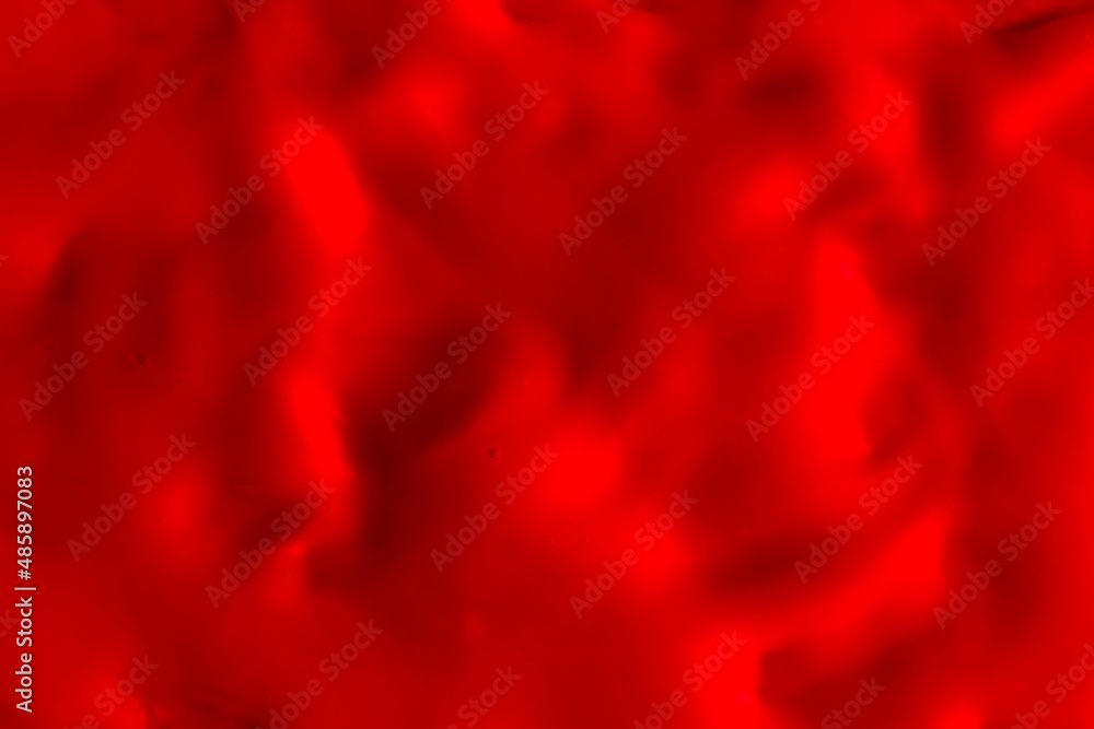 Background of red cream texture. Berry fruit yogurt or whipped cream. Smooth surface of body lacquer cream. Slime red.